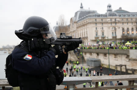 French policeman points a flash-ball gun a demonstration by the "yellow vests" movement in Paris, France, January 5, 2019. REUTERS/Gonzalo Fuentes