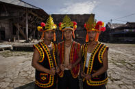 NIAS ISLAND, INDONESIA - FEBRUARY 22: A villagers wearing traditional costume pose in front of a stone tower in Bawomataluwo village on February 22, 2013 in Nias Island, Indonesia. Stone Jumping is a traditional ritual, with locals leaping over large stone towers, which in the past resulted in serious injury and death. Stone jumping in Nias Island was originally a tradition born of the habit of inter tribal fighting on the island of Nias. (Photo by Ulet Ifansasti/Getty Images)