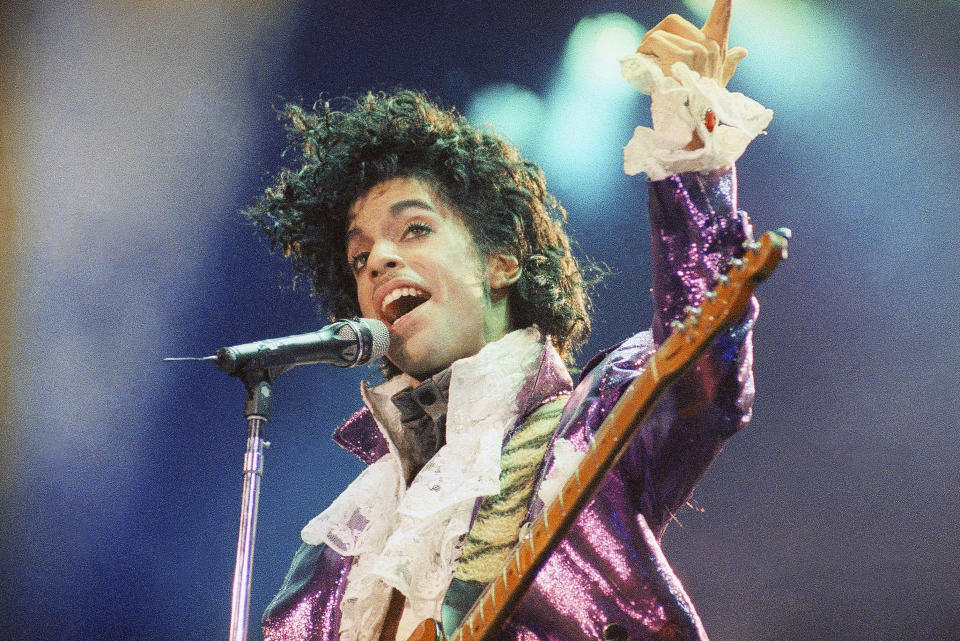 FILE - In this Feb. 18, 1985 file photo, Prince performs at the Forum in Inglewood, Calif. The music icon died of an accidental opioid overdose at his Paisley Park studio on April 21, 2016. He was 57. (AP Photo/Liu Heung Shing, File)