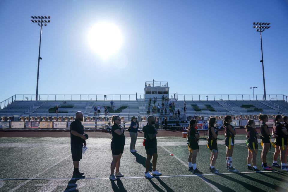 Campo Verde High School flag football head coach Brian Coger (left) attends a game against Canyon View High School at Campo Verde High School in Gilbert on Sept. 5, 2023.