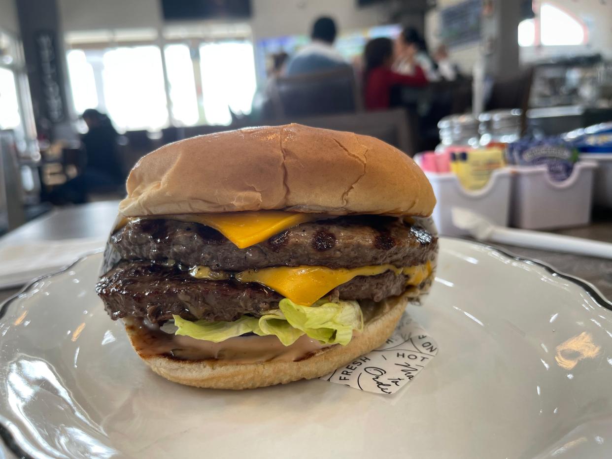 A juicy Angus beef double-cheeseburger from  Roundabout Grill in Victorville.