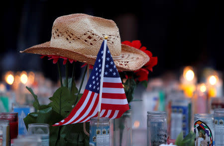 FILE PHOTO - A hat rests on flowers in a makeshift memorial during a vigil marking the one-week anniversary of the October 1 mass shooting in Las Vegas, Nevada U.S. October 8, 2017. REUTERS/Las Vegas Sun/Steve Marcus