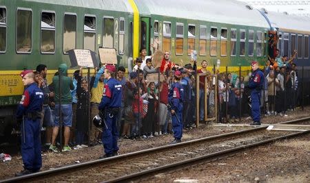 Migrants stage a protest in front of a train at Bicske railway station, Hungary, September 4, 2015. REUTERS/Leonhard Foeger