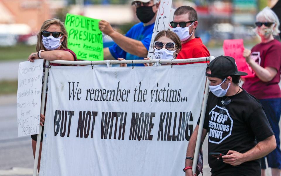 People gather to protest the resumption of federal executions near the US Penitentiary and execution chamber in Terre Haute, Indiana - TANNEN MAURY/EPA-EFE/Shutterstock/Shutterstock