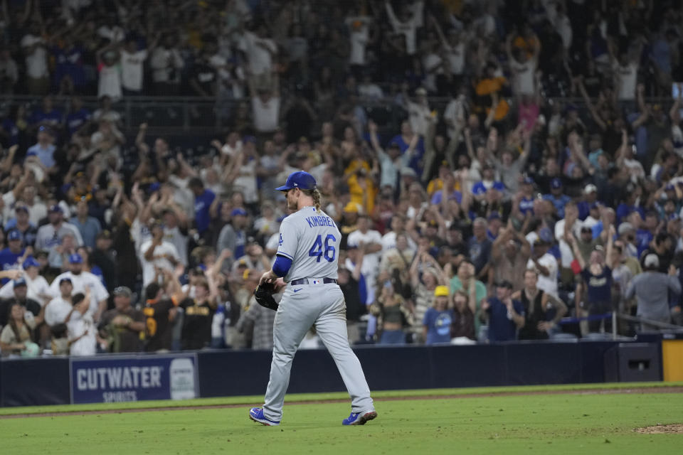 Los Angeles Dodgers relief pitcher Craig Kimbrel leaves the field after giving up a bases-loaded walk during the 10th inning of the team's baseball game against the San Diego Padres, Tuesday, Sept. 27, 2022, in San Diego. The Padres won 4-3. (AP Photo/Gregory Bull)