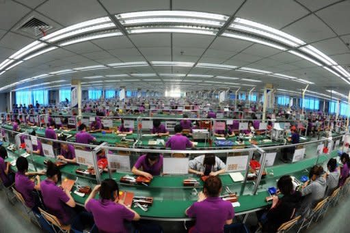 Staff work at an electronic products factory in Bozhou, east China's Anhui province in May 2012. China's manufacturing activity fell to a nine-month low in August as firms struggled with global woes, providing further impetus for Beijing to beef up economic stimulus efforts, HSBC said Thursday