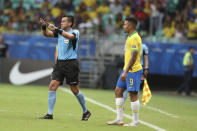 Referee Julio Bascunan disallows a goal scored by Brazil's Gabriel Jesus, right, after consulting the VAR during a Copa America Group A soccer match at the Arena Fonte Nova in Salvador, Brazil, Tuesday, June 18, 2019. (AP Photo/Ricardo Mazalan)