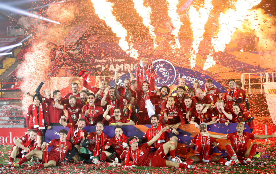 Soccer Football - Premier League - Liverpool v Chelsea - Anfield, Liverpool, Britain - July 22, 2020. Picture taken July 22, 2020   Liverpool's Jordan Henderson, teammates and staff celebrate with the trophy after winning the Premier League    Pool via REUTERS/Phil Noble EDITORIAL USE ONLY. No use with unauthorized audio, video, data, fixture lists, club/league logos or 'live' services. Online in-match use limited to 75 images, no video emulation. No use in betting, games or single club/league/player publications.  Please contact your account representative for further details.