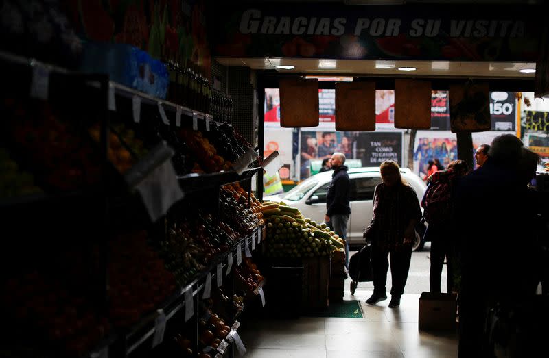 A costumer walks into a green grocery with a shopping cart, as Argentines struggle amid rising inflation, in Buenos Aires