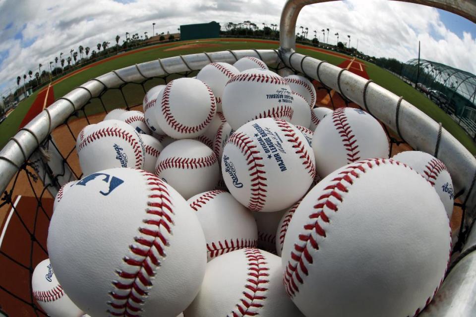 A basket of baseballs sits on the Honus Wagner practice field at the Pittsburgh Pirates practice facility on the team's first day of baseball spring training for pitchers and catchers in Bradenton, Fla., Thursday, Feb. 13, 2014. (AP Photo/Gene J. Puskar)