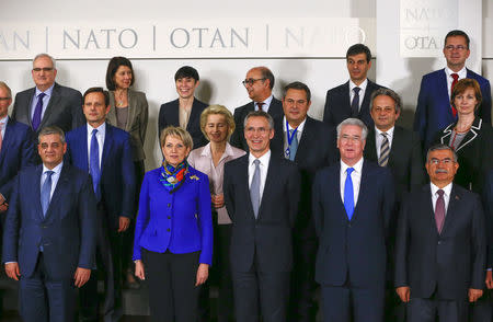 NATO Secretary General Jens Stoltenberg (C) poses for a group photo with defence ministers during a NATO defence ministers meeting at the Alliance's headquarters in Brussels, Belgium February 10, 2016. REUTERS/Yves Herman