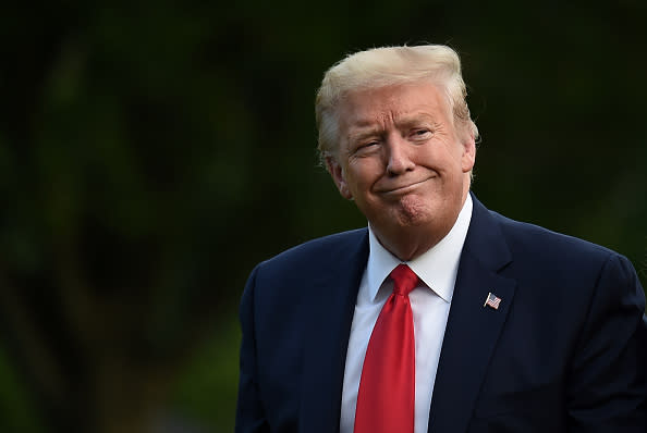 US President Donald Trump walks across the South Lawn upon his return to the White House in Washington, DC.