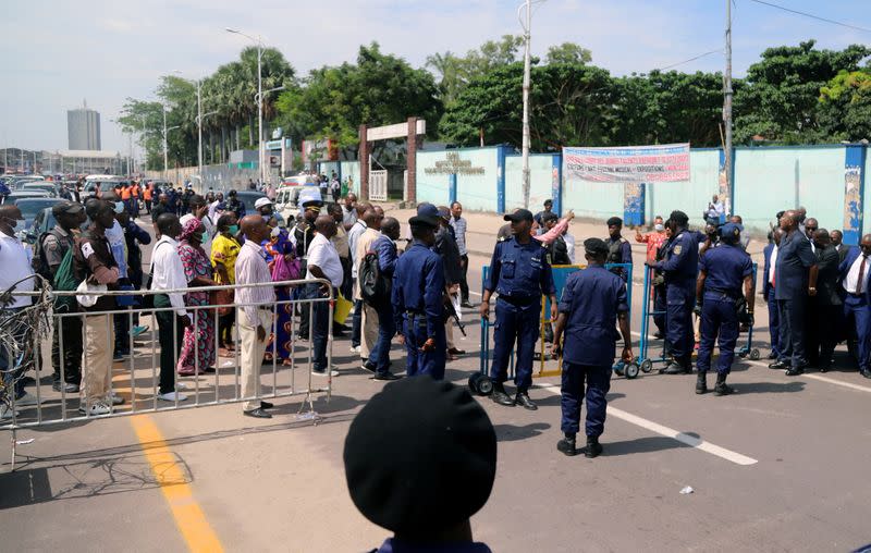 FILE PHOTO: Congolese police officers control civilians during a total lockdown amid concerns about the spread of the coronavirus disease (COVID-19), in Gombe commune of Kinshasa