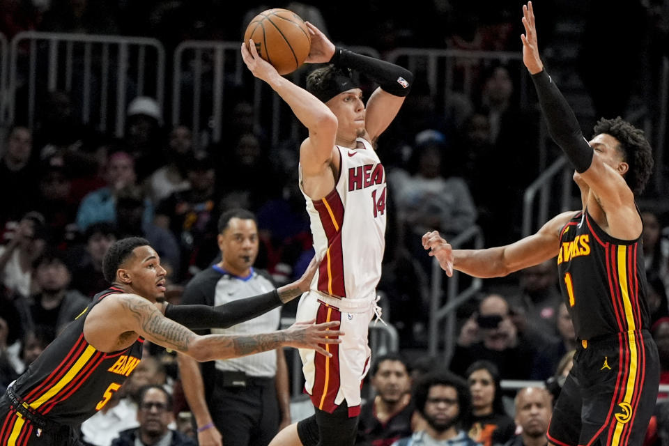 Miami Heat guard Tyler Herro (14) shoots against Atlanta Hawks forward Jalen Johnson (1) during the first half of an NBA basketball game, Tuesday, April 9, 2024, in Atlanta. (AP Photo/Mike Stewart)