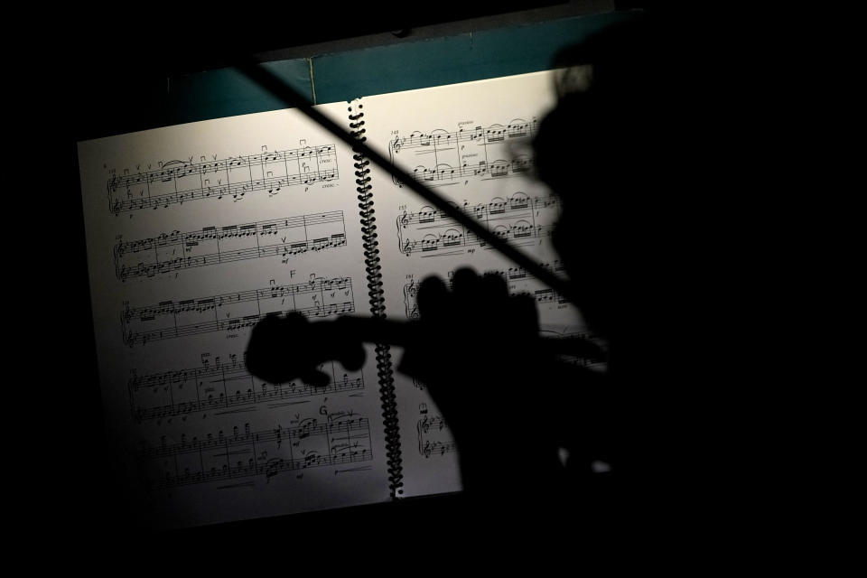 A Ballet Arizona musician rehearses for the "Nutcracker", Thursday, Dec. 7, 2023, in Phoenix prior to an upcoming performance. A pit full of musicians is part of the tradition of the holiday staple for Ballet Arizona and many other productions around the world. Shows use recordings as they weather costs or crises like recessions. But fans, musicians and the unions that represent them say the live music brings an unseen signature to each show. (AP Photo/Matt York)