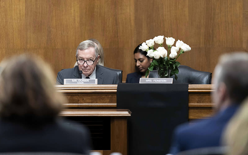 Senate Judiciary Chairman Richard Durbin (D-Ill.) looks on as the desk of late Sen. Dianne Feinstein (D-Calif.) is draped in black and set with white roses during a hearing