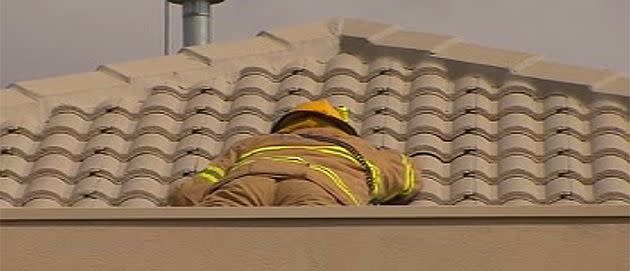 Rescuers work to free an elderly woman who was trapped in her roof for four days. Photo: 7News