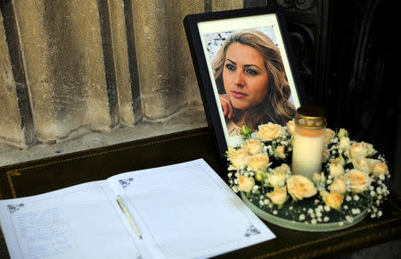 FILE PHOTO: A photograph of Bulgarian journalist Viktoria Marinova and a condolence book are seen before her funeral service in Holy Trinity Cathedral in Ruse, Bulgaria, October 12, 2018. REUTERS/Stoyan Nenov/File Photo