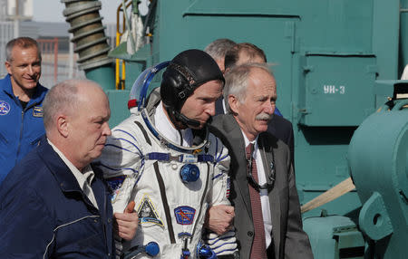 International Space Station (ISS) crew member astronaut Nick Hague of the U.S. walks to board the Soyuz MS-10 spacecraft for the launch at the Baikonur Cosmodrome, Kazakhstan October 11, 2018. Yuri Kochetkov/Pool via REUTERS