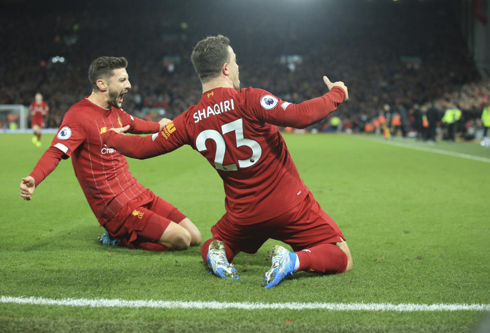 Liverpool's Xherdan Shaqiri, right, celebrates his goal against Everton during the English Premier League soccer match between Liverpool and Everton at Anfield Stadium, Liverpool, England, Wednesday, Dec. 4, 2019. (AP Photo/Jon Super)