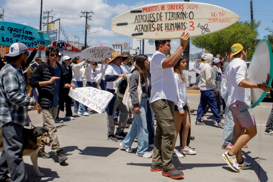 Locals march to protest the disappearance of foreign surfers in Ensenada, Mexico, Sunday, May 5, 2024. Mexican authorities said Friday that three bodies were recovered in an area of Baja California near where two Australians and an American went missing last weekend during an apparent camping and surfing trip. (AP Photo/Karen Castaneda)