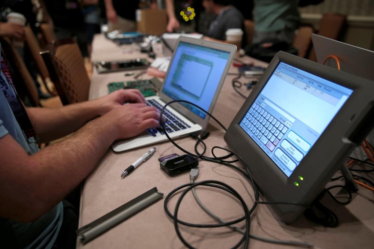 A hacker tries to access and alter data during a hacker convention in Nevada in 2017.  (Steve Marcus/Reuters - image credit)