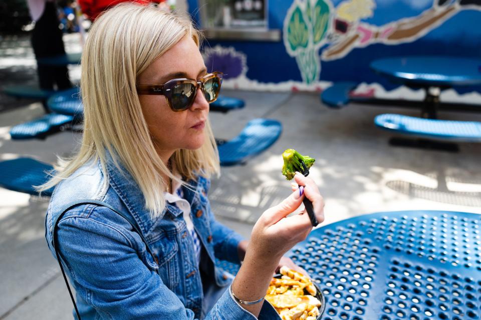 Deseret News feature writer Meg Walter eats at Teriyaki Stix at the Lagoon Amusement Park in Farmington on Monday, June 12, 2023. | Ryan Sun, Deseret News