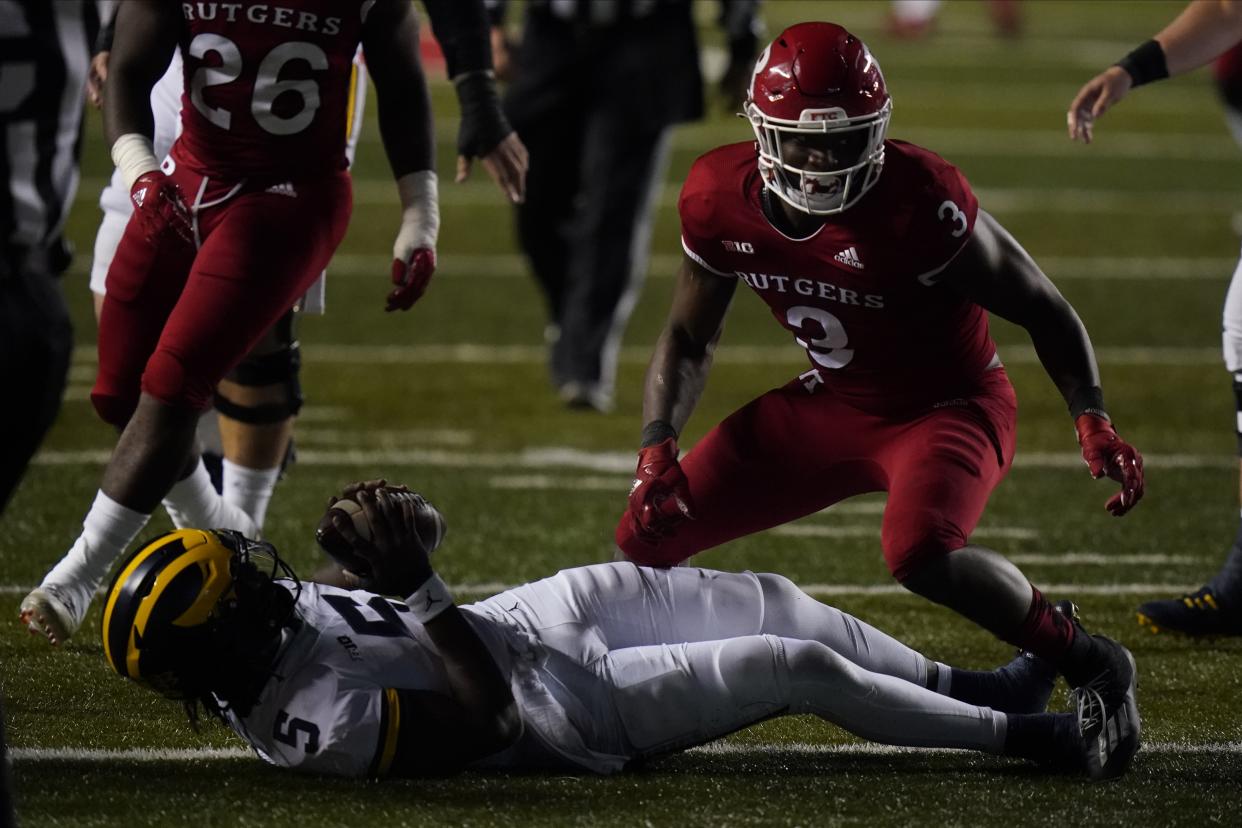 Rutgers' Olakunle Fatukasi (3) sacks Michigan's Joe Milton (5) last week. (AP Photo/Frank Franklin II)