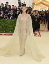 <p>Rosie Huntington-Whiteley looked almost angelic in this flowing gold cape dress by Ralph Lauren, with a matching gold halo headpiece. Photo: Getty Images </p>