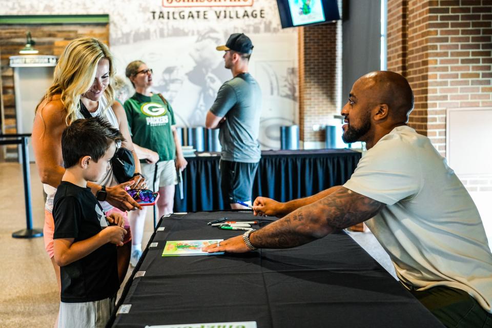 Green Bay Packers running back AJ Dillon meets with local fans during the book signing for his new children's book, "Quadzilla Finds His Footing," on Tuesday in Green Bay.