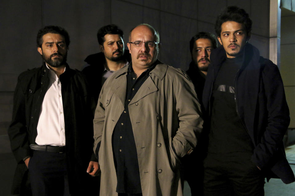 This undated promotional handout still from the Iranian state TV series, “Gando,” shows actor Payam Dehkordi, center, who plays a character apparently based on Washington Post journalist Jason Rezaian, among other actors. The new Iranian television series is glorifying the hard-liners and intelligence officers behind the 2014 arrest and imprisonment of Rezaian. (Mohammad Bagheri/TV series, “Gando,” via AP)