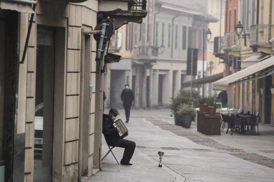 A man plays an accordion in Codogno, northern Italy, Sunday, Feb. 21, 2021. The first case of locally spread COVID-19 in Europe was found in the small town of Codogno, Italy one year ago on February 21st, 2020. The next day the area became a red zone, locked down and cutoff from the rest of Italy with soldiers standing at roadblocks keeping anyone from entering of leaving. (AP Photo/Luca Bruno)