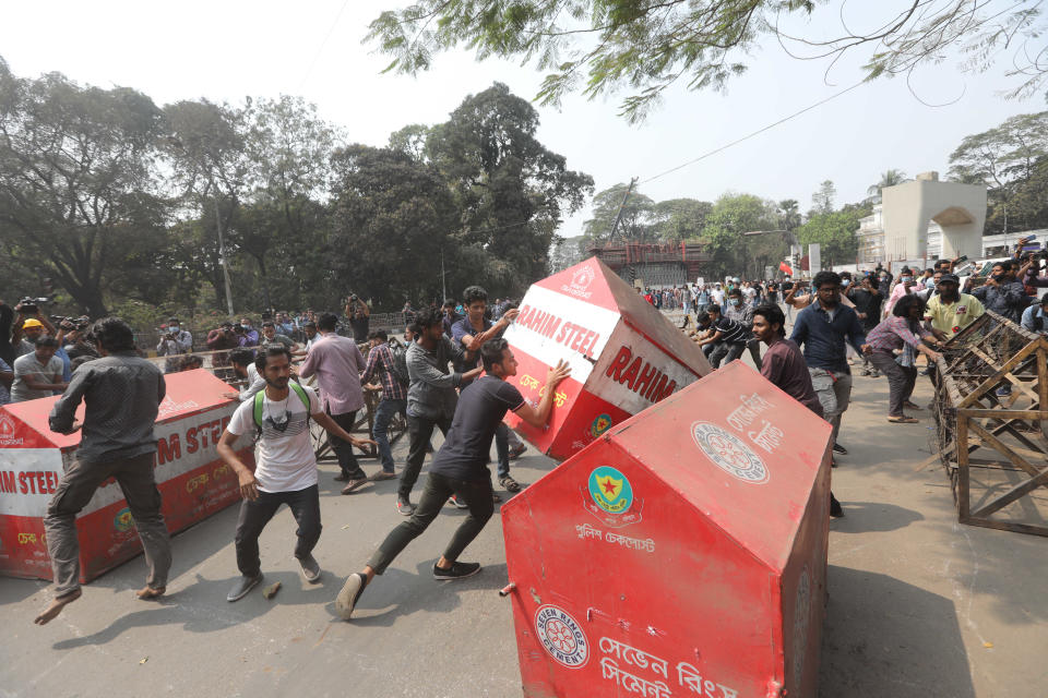 Bangladeshi students overturn security barricades outside the Home Ministry during a protest in Dhaka, Bangladesh, Monday, March 1, 2021. About 300 student activists rallied in Bangladesh’s capital on Monday to denounce the death in prison of Mushtaq Ahmed, a writer and commentator who was arrested last year on charges of violating a sweeping digital security law that critics say chokes freedom of expression. (AP Photo/Mahmud Hossain Opu)