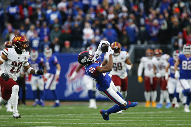 New York Giants' Isaiah Hodgins catches a touchdown pass during the second  half of an NFL football game against the Washington Commanders, Sunday, Dec.  4, 2022, in East Rutherford, N.J. (AP Photo/John