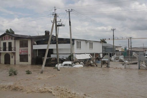 A handout photo released by Russia's Interior Ministry shows a stranded car on a flooded street of the city of Krymsk. Flash floods deluged Russia's southern Krasnodar, killing at least 134 people -- many feared drowned in their beds -- in the region's worst natural disaster in decades, officials and witnesses said Saturday