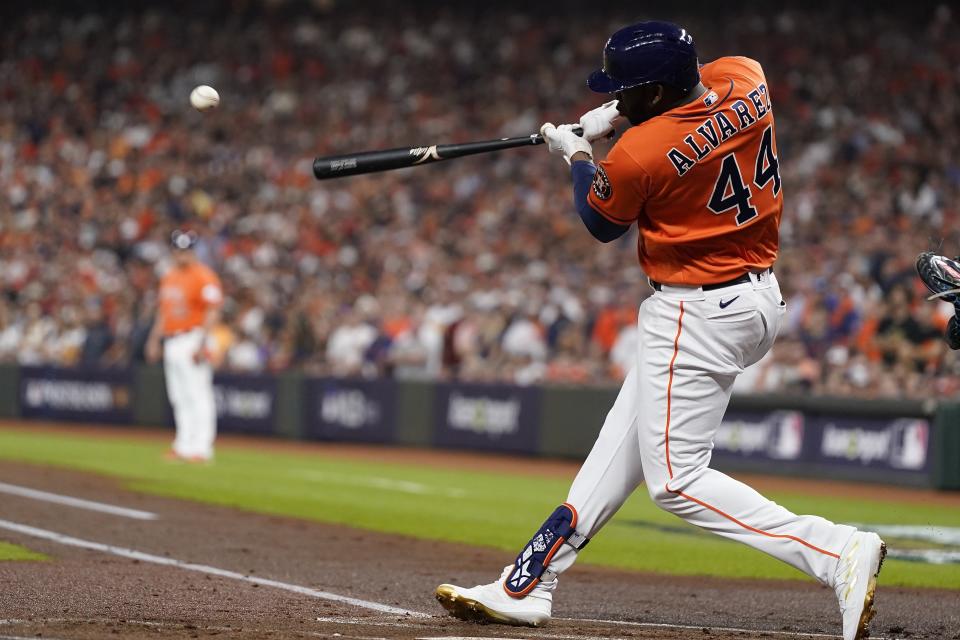 Houston Astros' Yordan Alvarez hits an RBI single during the first inning of Game 6 of the baseball AL Championship Series against the Texas Rangers Sunday, Oct. 22, 2023, in Houston. (AP Photo/Godofredo A. Vásquez)