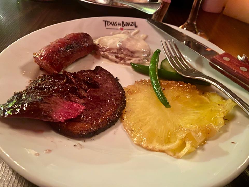 laurens plate full of meat and sides at texas de brazil steak house