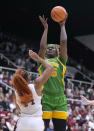 Oregon center Phillipina Kyei (15) takes a shot over Stanford forward Kiki Iriafen (44) during the first half of an NCAA college basketball game Friday, Jan. 19, 2024, in Stanford, Calif. (AP Photo/Tony Avelar)