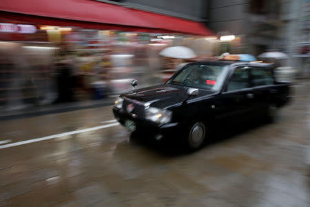 A taxi drives through a shopping district in Osaka, western Japan October 22, 2017. Picture taken October 22, 2017 REUTERS/Thomas White