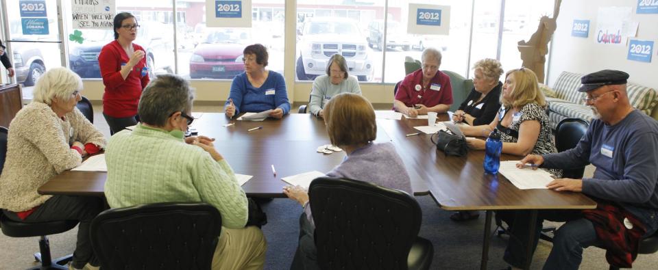 This photo taken on March 14, 2012 shows Tami Parker, standing left, a regional field director for the Obama campaign, instructing phone bank volunteers at a Obama campaign office in Lakewood, Colo. A handful of nurses and other volunteers took up their cell phones last week to call voters and talk up the health care overhaul. The volunteers were targeting elderly women. Holding up a sheet of talking points about the health law, campaign field director Tami Parker told about a dozen volunteers that the health care law faces a Supreme Court challenge later this month. "We need to talk about how the American Care Act helps women, especially elderly women," Parker said. The talking points ended with an argument in bold: "Some politicians want to take away these new benefits, and put insurance companies back in charge." (AP Photo/Ed Andrieski)
