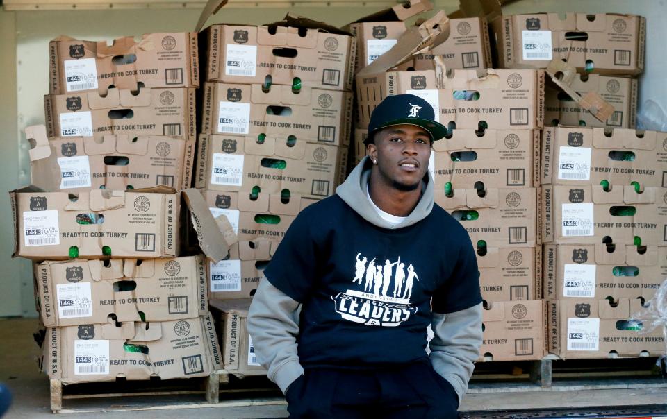 Tim Anderson, a Major League Baseball player with the Chicago White Sox and a graduate of Hillcrest High in Tuscaloosa County, sits on the gate of a truck containing 205 turkeys at the school Tuesday, Nov. 23, 2021. Anderson gave away the birds to help with Thanksgiving meals through his charity, Anderson's League of Leaders. [Staff Photo/Gary Cosby Jr.]