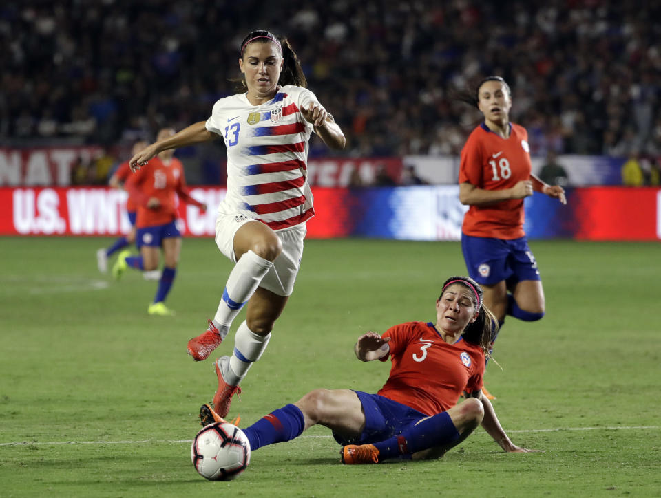 United States' Alex Morgan leaps over a slide tackle from Chile's Carla Guerrero during the first half of an international friendly soccer match Friday, Aug. 31, 2018, in Carson, Calif. (AP Photo/Marcio Jose Sanchez)