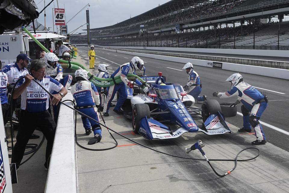 Alex Palou, of Spain, makes a pit stop during the IndyCar Grand Prix auto race at Indianapolis Motor Speedway, Saturday, May 13, 2023, in Indianapolis. (AP Photo/Darron Cummings)