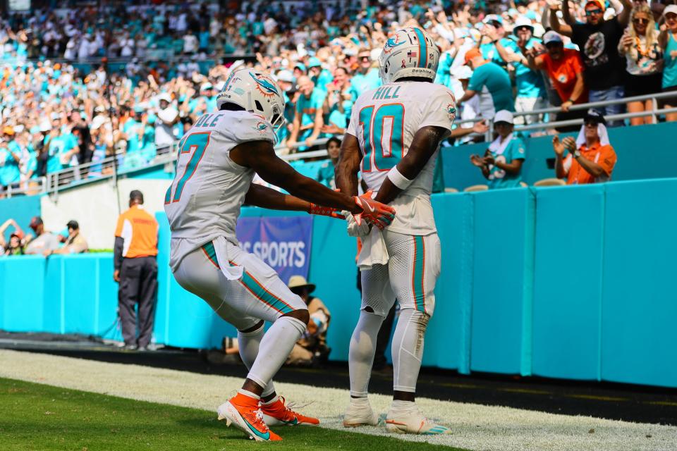 Dolphins receiver Tyreek Hill celebrates his touchdown with Jaylen Waddle (17). Hill had been handcuffed and detained by police while entering the Hard Rock Stadium parking lot before the game.