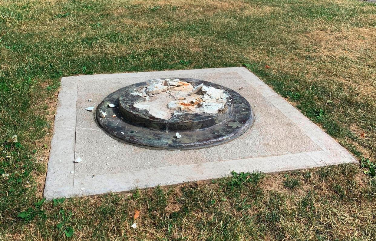 The remnants of a Frederick Douglass statue ripped from its base at a park in Rochester, New York: AP / WROC-TV