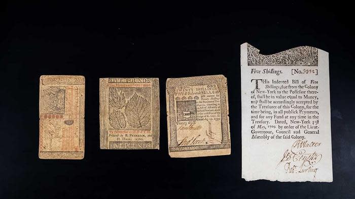 Four examples of colonial paper currency on a black background. Khachatur Manukyan and his team employed cutting-edge spectroscopic and imaging instruments to get a closer look than ever at the inks, paper and fibers that made Benjamin Franklin’s bills distinctive and hard to replicate. 