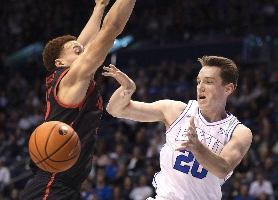Brigham Young Cougars guard Spencer Johnson (20) passes the ball past San Diego State Aztecs forward Elijah Saunders (25) as BYU and San Diego State compete at BYU’s Marriott Center in Provo on Friday, Nov. 10, 2023. | Laura Seitz, Deseret News