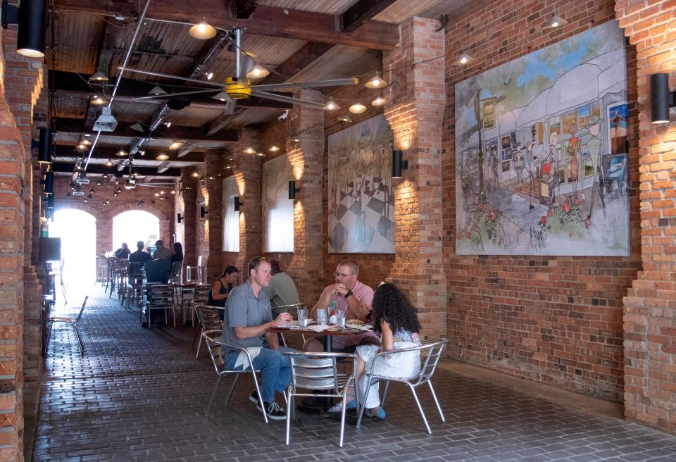 New pieces of artwork hung on the walls are among the recent changes at the Wine Bar on Palafox Place in downtown Pensacola on Tuesday, June 2, 2020.