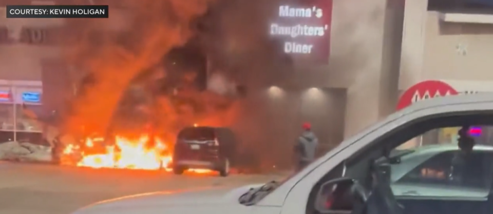 The plane caught fire as it crashed into the parking lot (CBS)