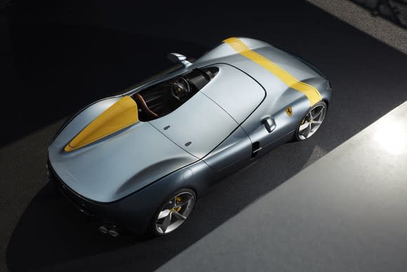 A Ferrari Monza SP1, a single-seat open-top car, silver with yellow racing stripe, viewed from above.